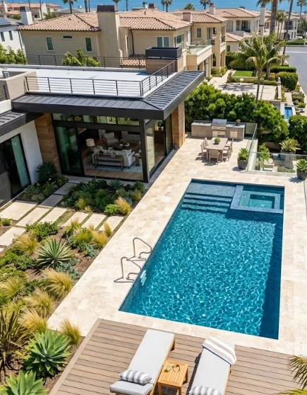 Beautiful aerial view of sparkling residential pool requiring Huntington Beach pool cleaning and maintenance services